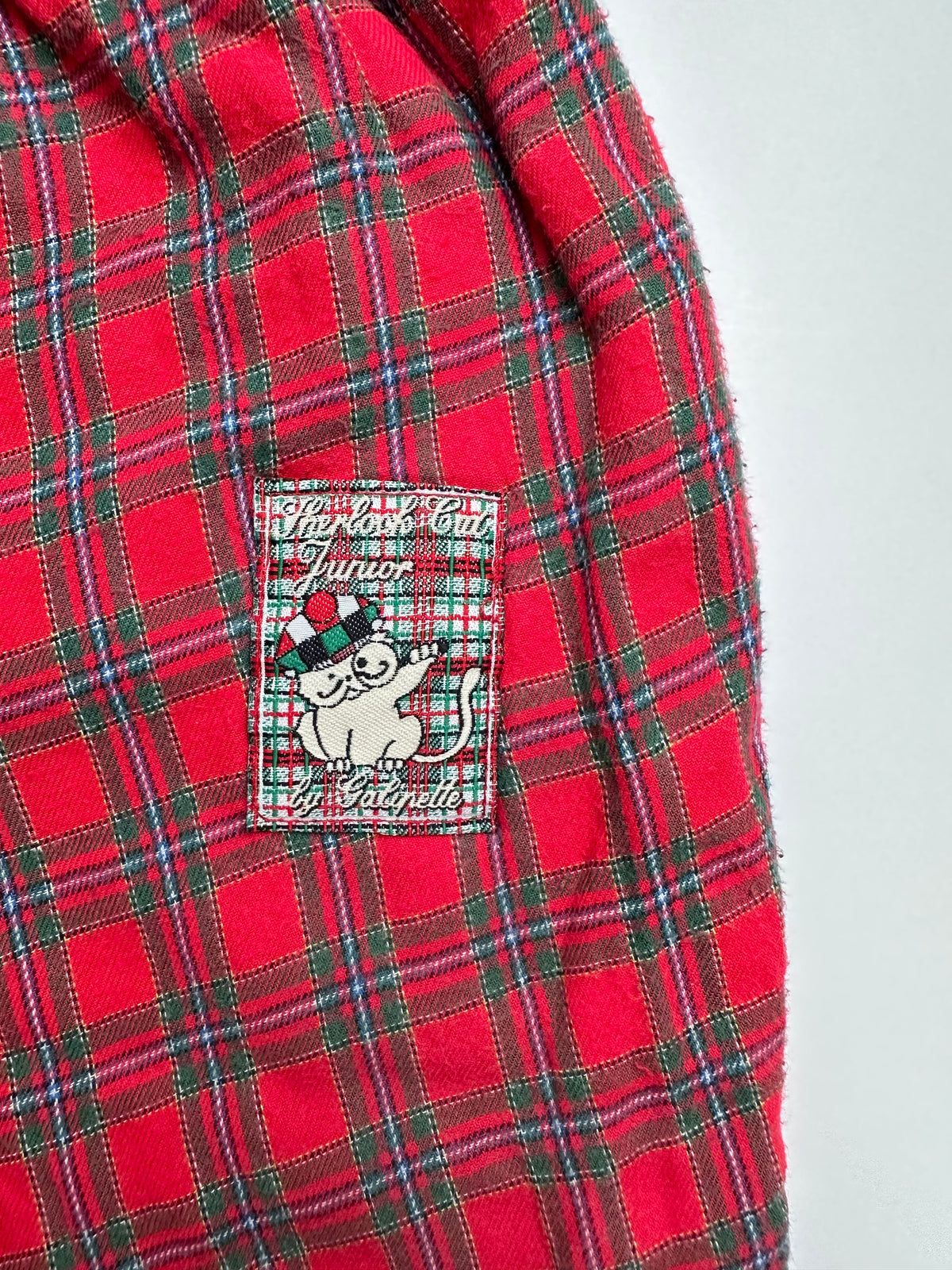 Lined Red check trousers on a white background