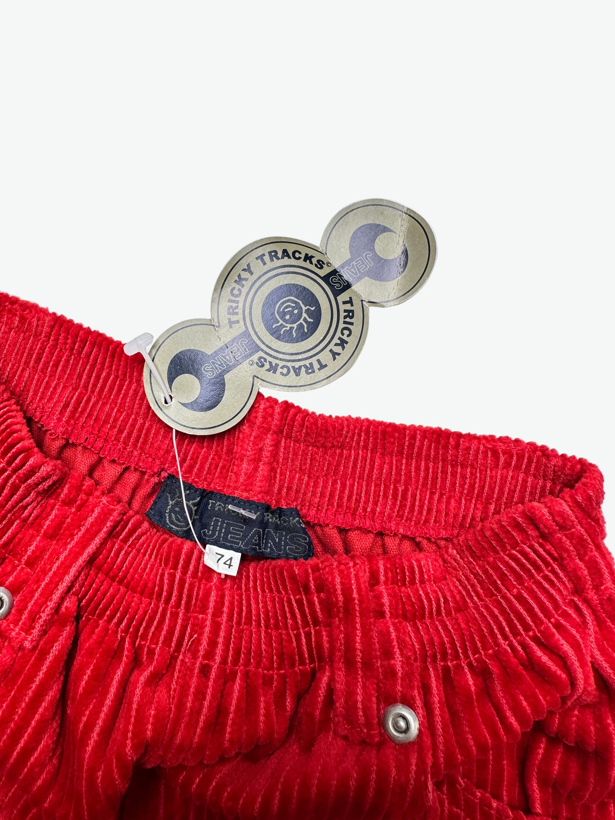 Close up of Red corduroy trousers on a white background