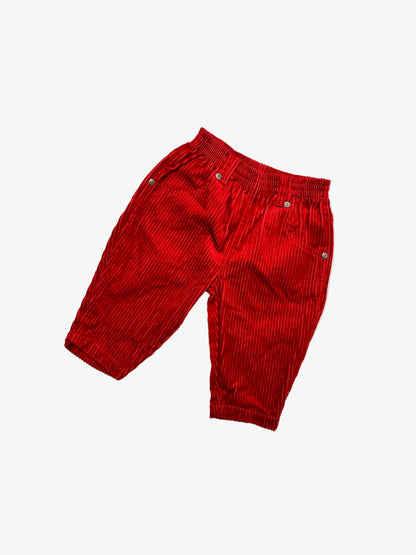Red corduroy trousers on a white background