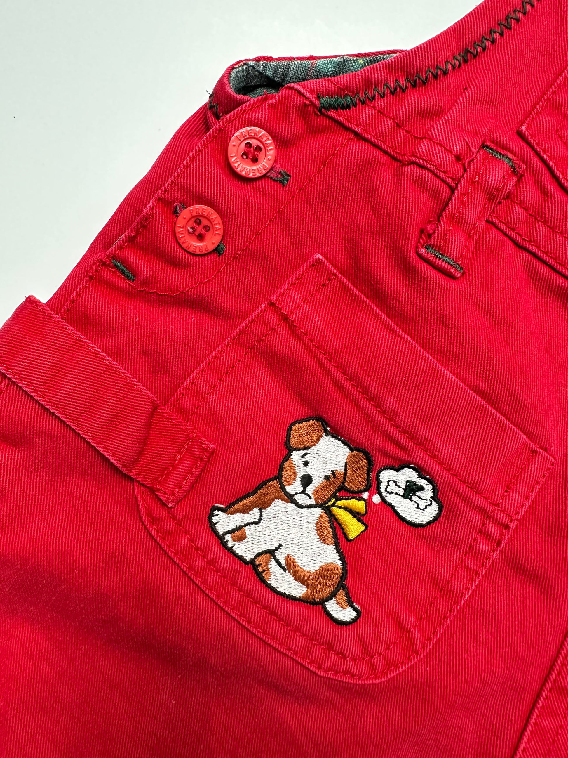 Kids vintage Red dungarees with a little dog embroidery on a white background