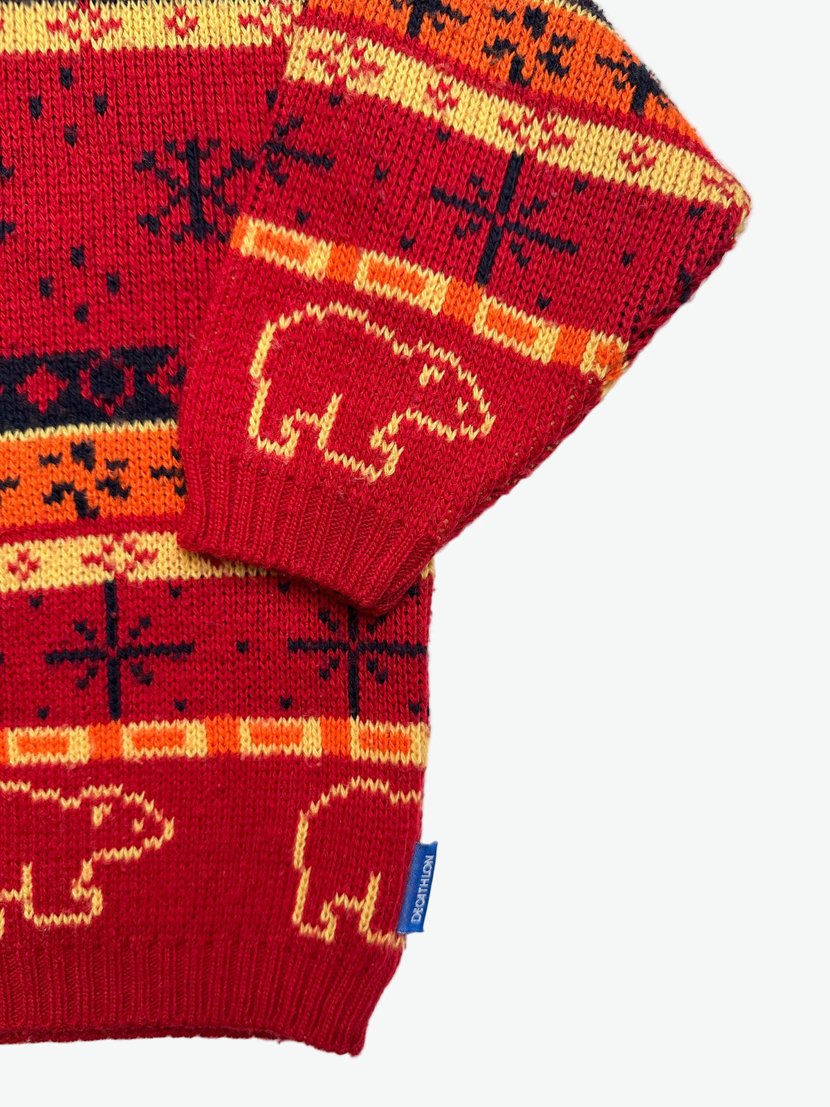 Kids vintage red sweater with snowflake and polar bear pattern on a white background