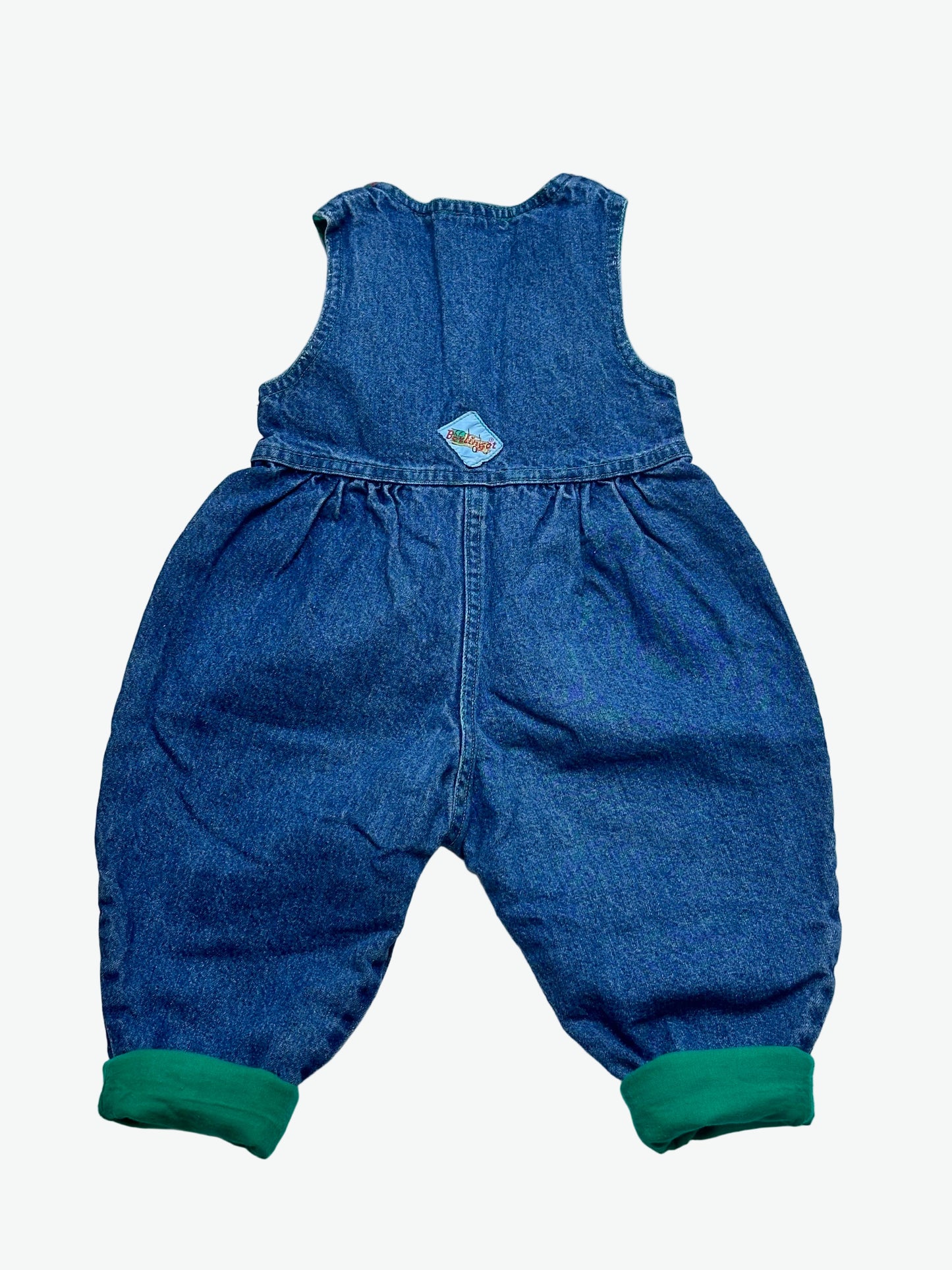 True blue denim romper lined with green cuffs on a white background
