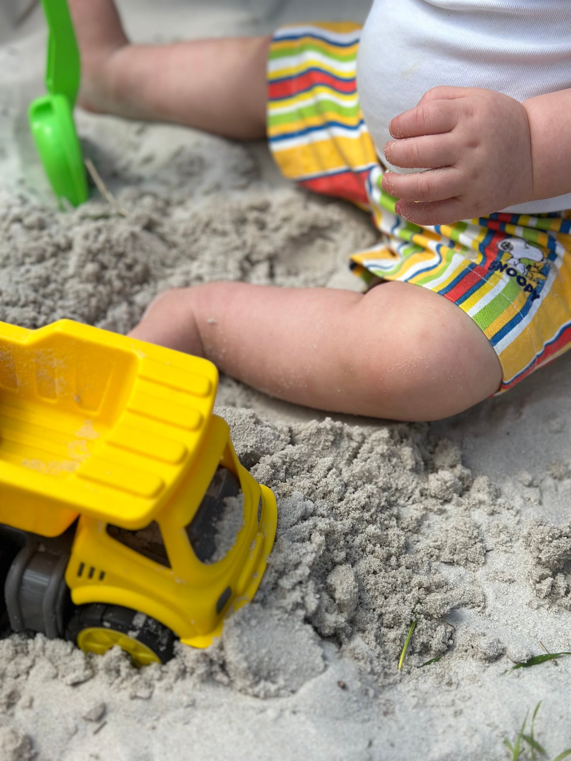 Kids Snoopy shorts, Striped multi-colour, Age 1 -2 years. Colourful summer. Playing in the sand. 