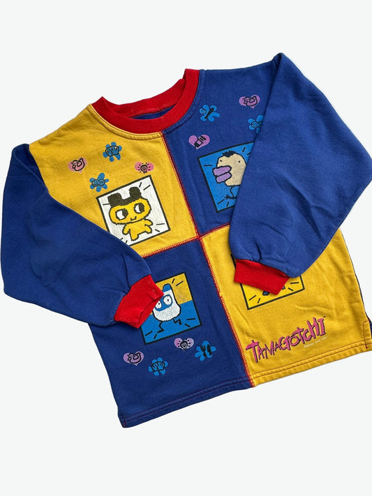 Kids vintage jumper branded Tamagotchi. Multi colour - red, blue and yellow, printed detail from 1996-1997. Age 10 years. 