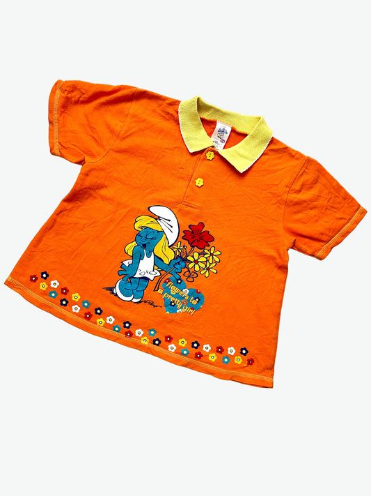 kids vintage orange tshirt with a collar and flower buttons. Featuring a print of Smurfette and words saying flowers to a pretty girl.