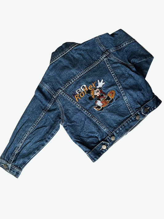 Kids vintage dark blue denim jacket with Mickey mouse on a skateboard embroidered design on the back on a white background