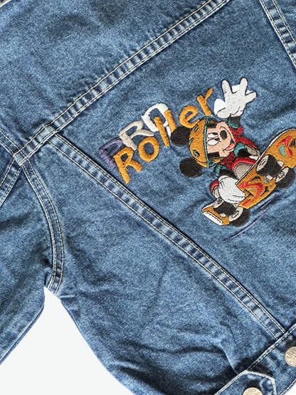 Kids vintage dark blue denim jacket with Mickey mouse on a skateboard embroidered design on the back on a white background